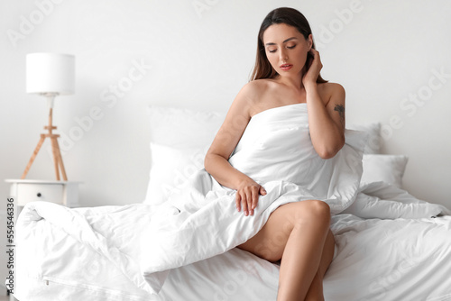 Young woman with blanket si...