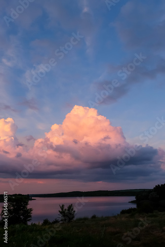 Landscape with river and beautiful clouds at sunset
