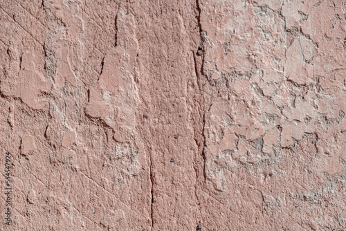 the structure of an old wall made of bricks and clay with red plaster. background with copy space