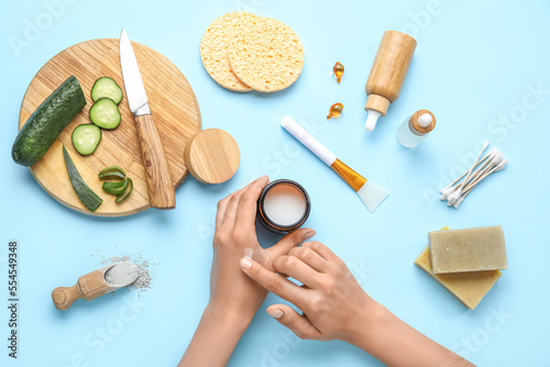 Woman applying cream onto h...