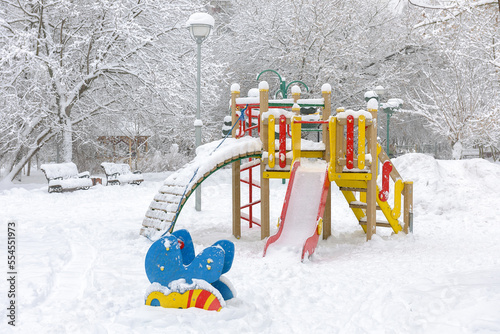 Snow in urban park in winter, Moscow, Russia. Scenic view of snowy empty playground photo