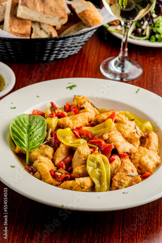 Italian Chicken. Chicken Cacciatore. Italian cuisine, alla cacciatora refers to a meal prepared "hunter-style" with onions, herbs, usually tomatoes, often bell peppers, and cooking wine. 