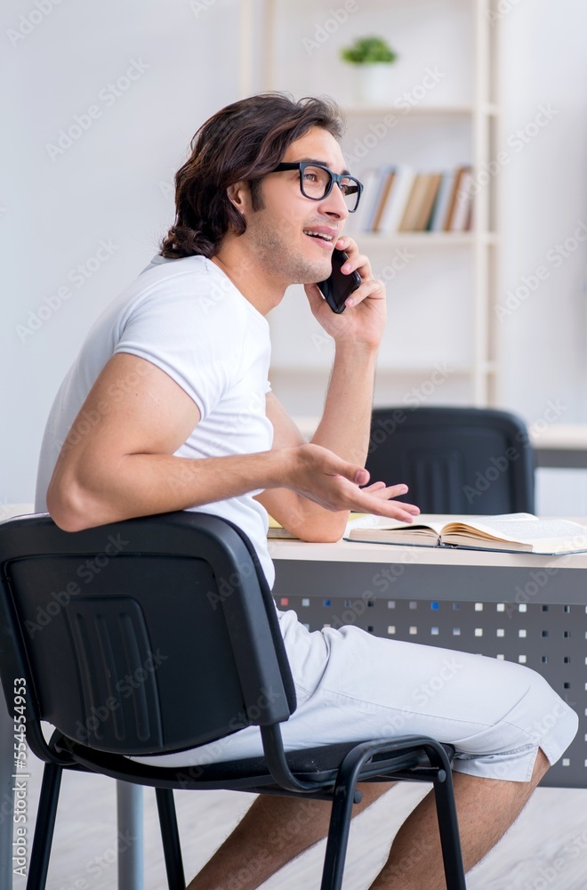 Young male student in front of whiteboard