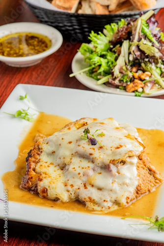 Veal parmigiana. Traditional Italian comfort dish. Chicken breast covered in breadcrumbs fried, topped with marinara sauce, melted mozzarella, parmigiana and provolone cheeses and Italian parsley
