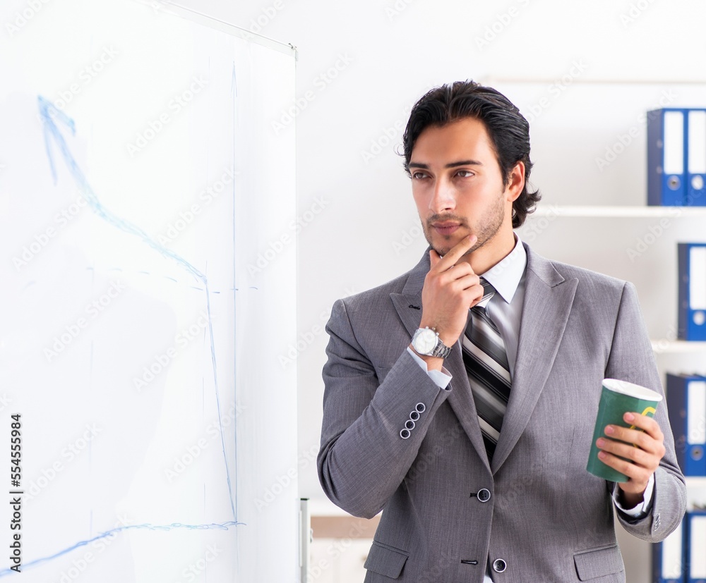 Young handsome businessman in front of whiteboard Young handsome businessman in front of whiteboard