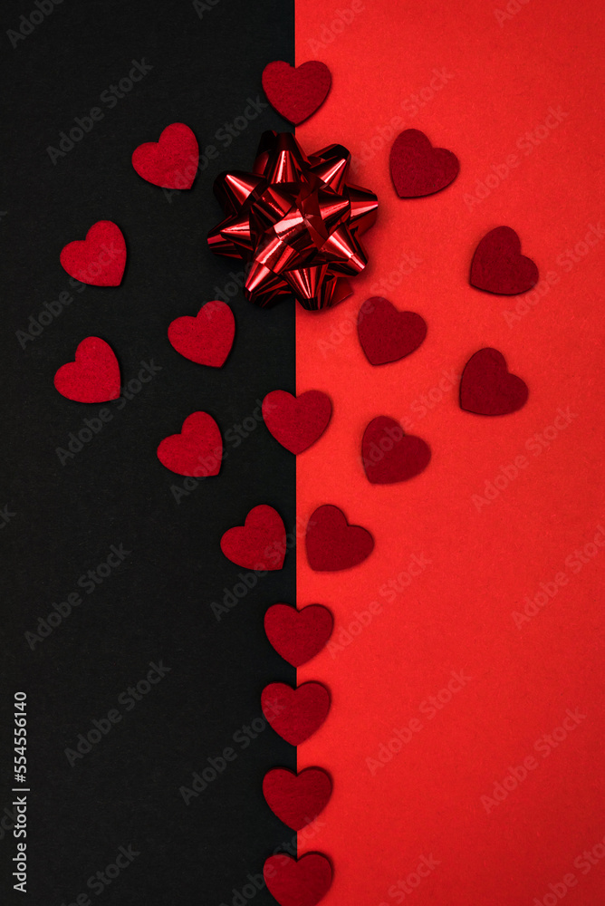 Black and red background decorated with a red bow and red hearts, a banner for discounts or congratulations Black and red background decorated with a red bow and red hearts, a banner for discounts or congratulations