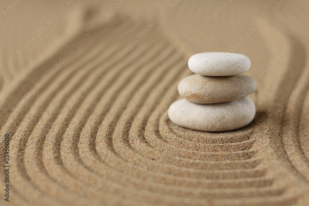 Japanese zen garden meditation, stone background with stones and lines in the sand for relaxation balance and harmony spirituality or wellness spa, calm pastel beige color. - obrazy, fototapety, plakaty 