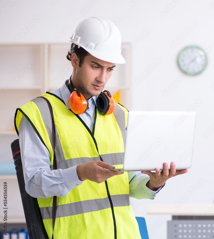 Young male architect working in the office Young male architect working in the office