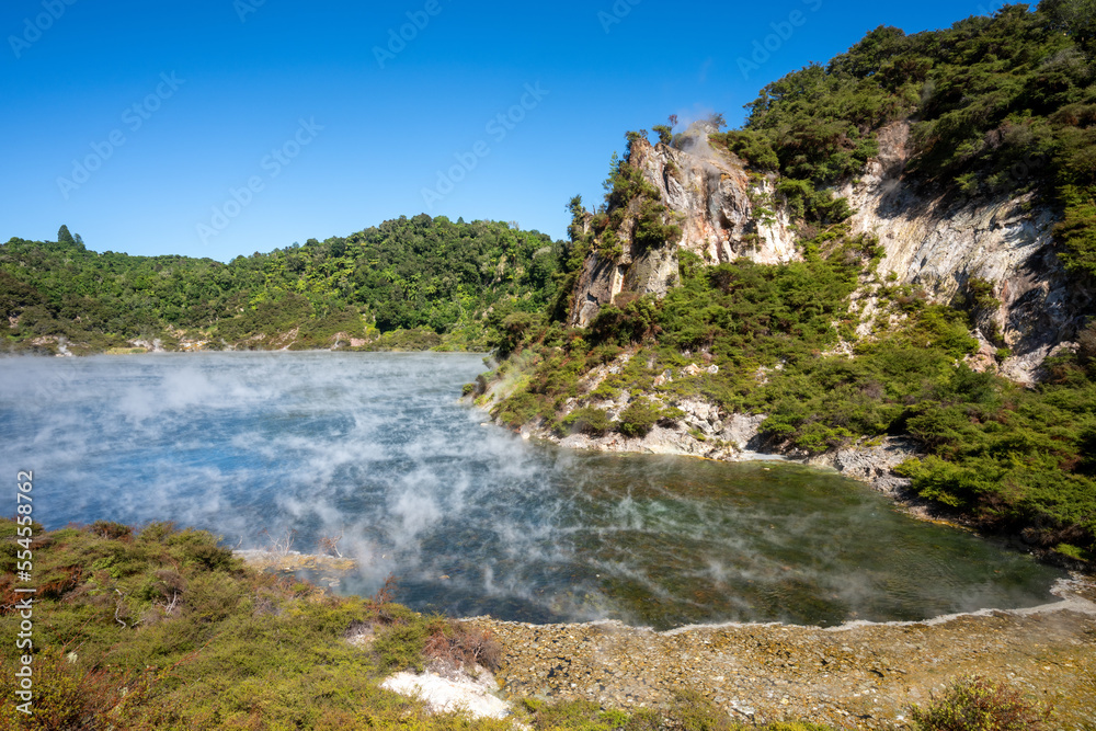 Steam rising from a lake at waimangu volcanic valley in Rotorua New Zealand