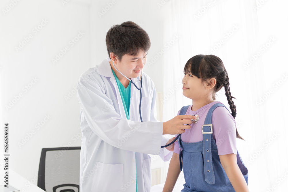 Asian doctor talk with children patient about disease symptom, doctor use stethoscope listening lung of patient, children health check up, happiness hospital Asian doctor talk with children patient about disease symptom, doctor use stethoscope listening lung of patient, children health check up, happiness hospital