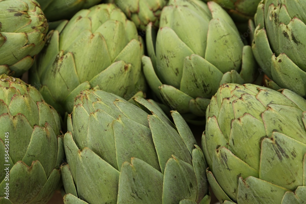 Fototapeta premium Many fresh raw artichokes as background, closeup
