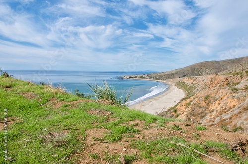 View of Leo Carillo state beach from distance blue sky clouds Malibu California