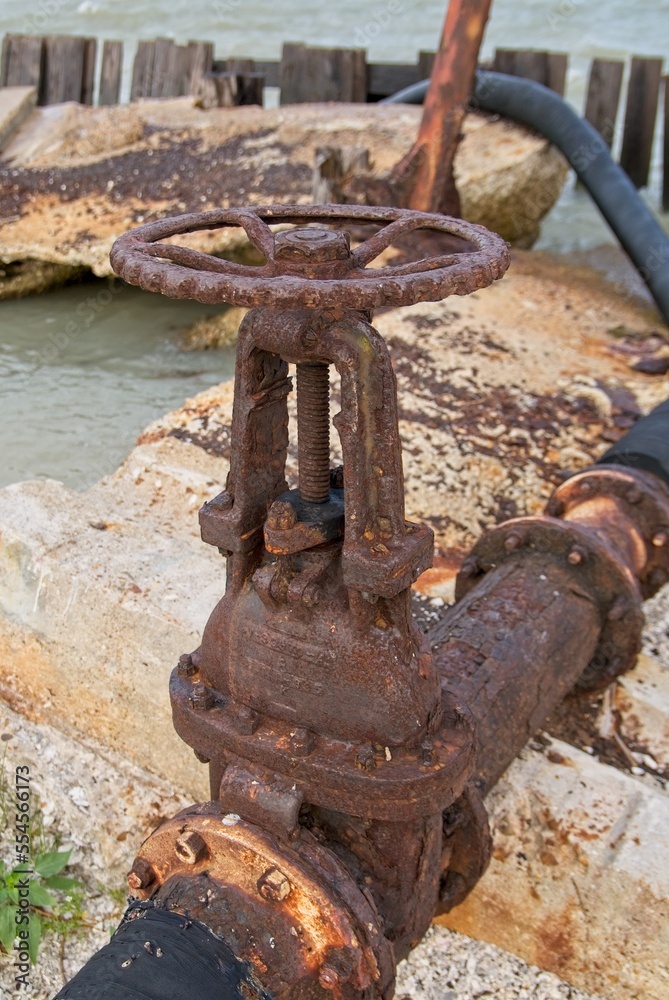 weathered gate valve on sea wall weathered gate valve on sea wall