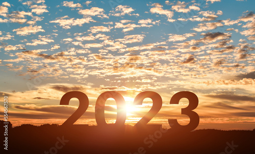 Happy New year 2023 year. Silhouette number of 2023 letters on the mountain with sunset sky. Starting to New Year concept