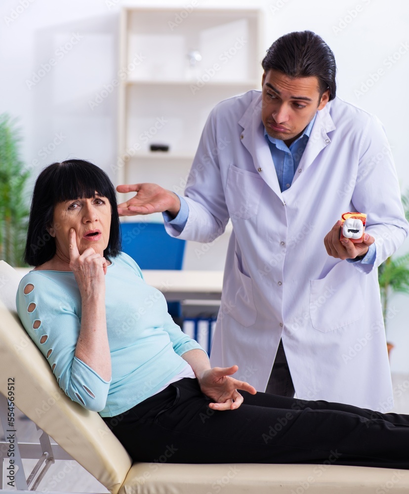 Fototapeta premium Old woman visiting young doctor dentist