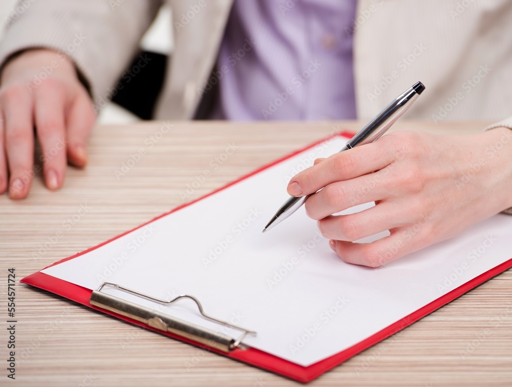 Hands taking notes in the pad
