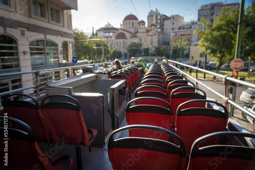 View from open roof of red, turistic hop on bus with tourists inside. Vacation, travel concept photo