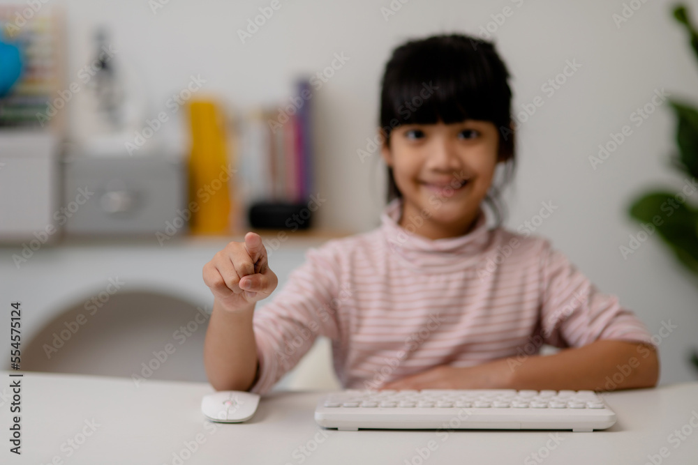 education, school, and imaginary screen concept - Asian little girl pointing in the air or imaginary screen education, school, and imaginary screen concept - Asian little girl pointing in the air or imaginary screen