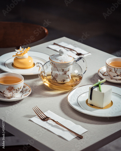 Tea time with French fine desserts on a table. High tea with petite gateau