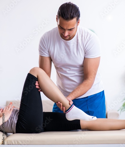 Young woman visiting male doctor physiotherapist
