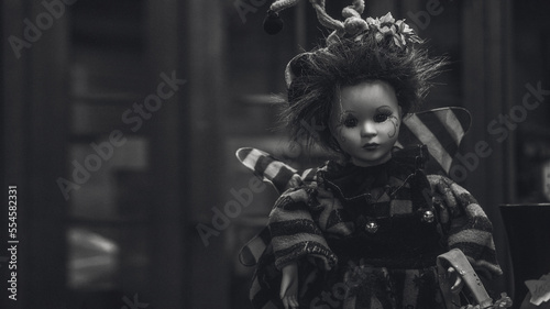 Scary children's doll from horror movies. Monochrome toy portrait..