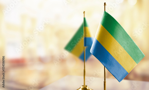 Small flags of the Gabon on an abstract blurry background