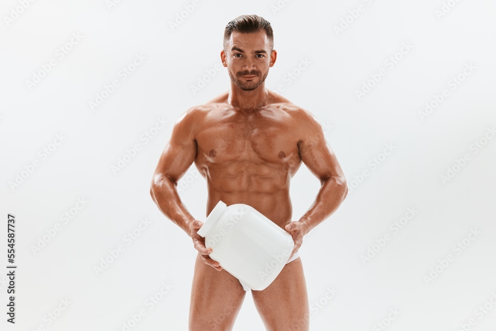 Man bodybuilder boxer with naked torso with abs holding a can of muscle growth pills, steroids, doping, protein. Advertising, sports, active lifestyle, competition, challenge concept. 