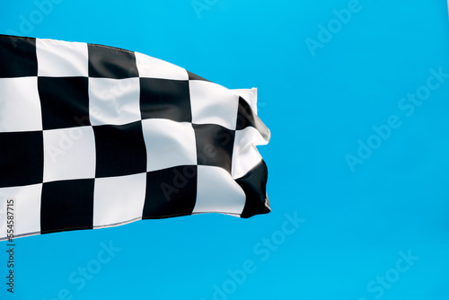 Checkered flag waving on blue background