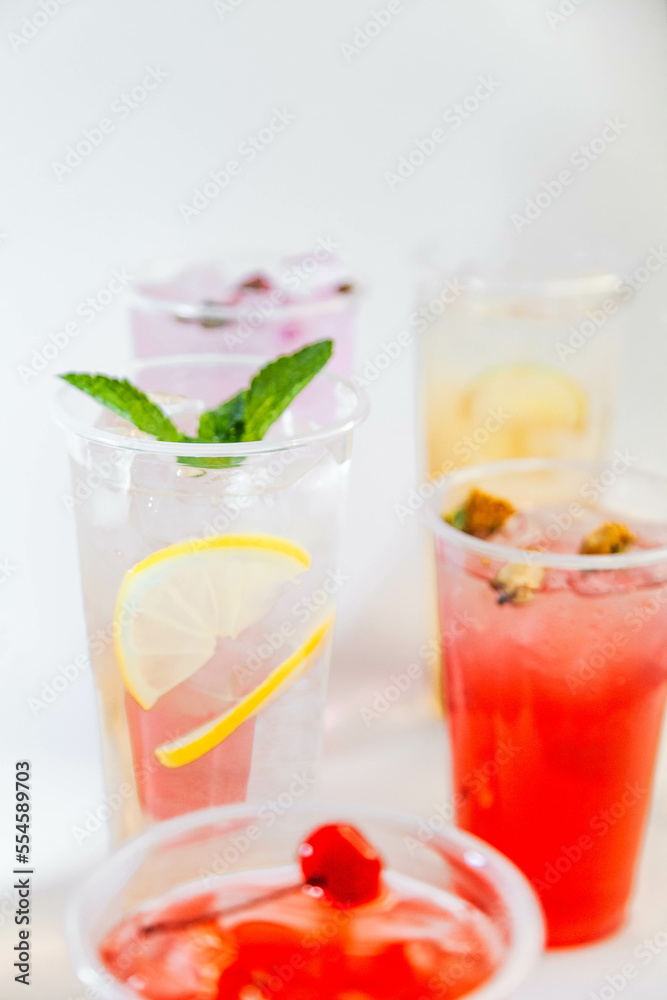 Set of different colors of lemonades and different flavors on a white background and against each other Set of different colors of lemonades and different flavors on a white background and against each other