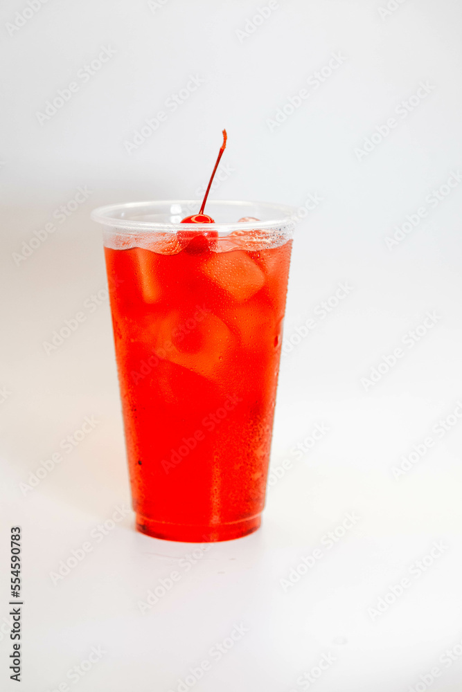 Red cherry lemonade with ice and cherries on a white background. view from above Red cherry lemonade with ice and cherries on a white background. view from above