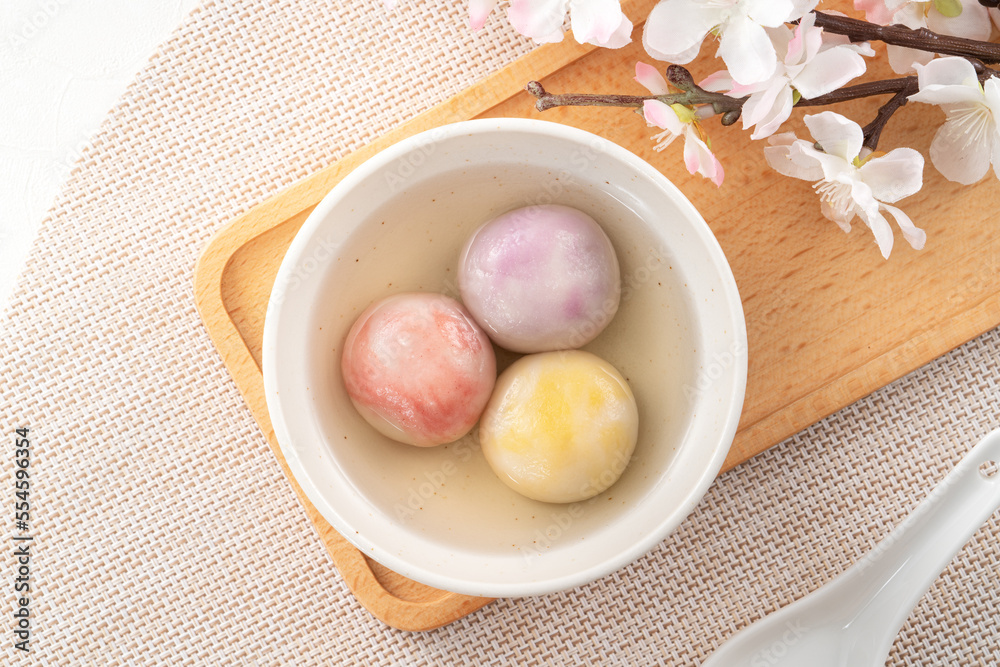 Colored glaze style big tangyuan with cherry blossom flower and syrup soup.