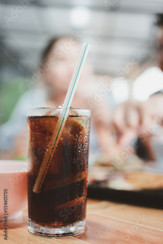 Soft drink in glasses with ice on the table with woman blur background at Thai local restaurants