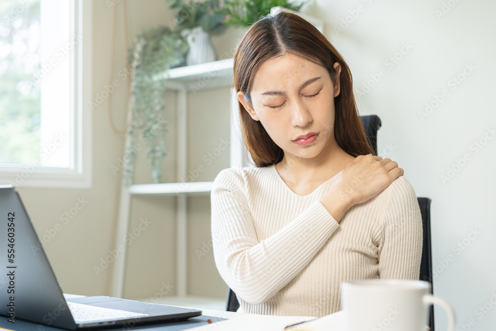 Body muscles stiff problem, ache asian young woman, girl pain shoulder while sitting work on chair at home, holding massaging rubbing, hurt or sore, Healthcare people, office syndrome . Body muscles stiff problem, ache asian young woman, girl pain shoulder while sitting work on chair at home, holding massaging rubbing, hurt or sore, Healthcare people, office syndrome .