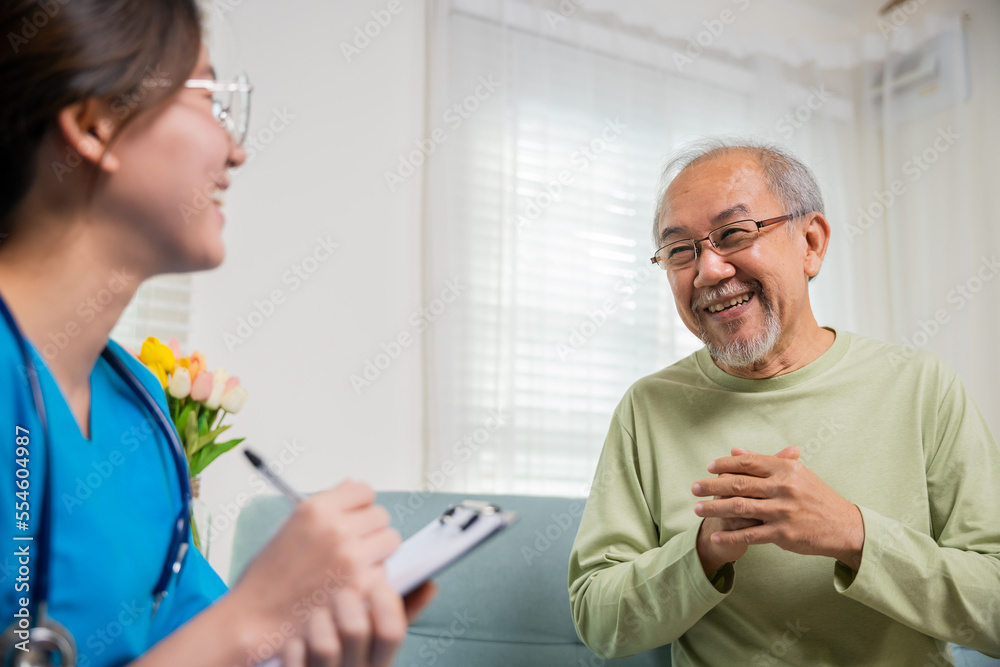 Elderly man takes doctor at home telling about health complaints, Asian young nurse writing prescription clipboard while talking during home visit sick senior old man, Healthcare and medical concept Elderly man takes doctor at home telling about health complaints, Asian young nurse writing prescription clipboard while talking during home visit sick senior old man, Healthcare and medical concept
