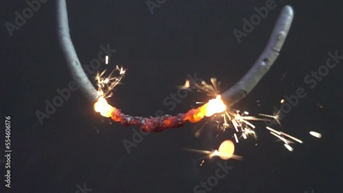 Sparkler pyrotechnics with black background in slow motion 1000 fps. Sparkling new years eve party, festive pyro with sprakling golden effect. photo