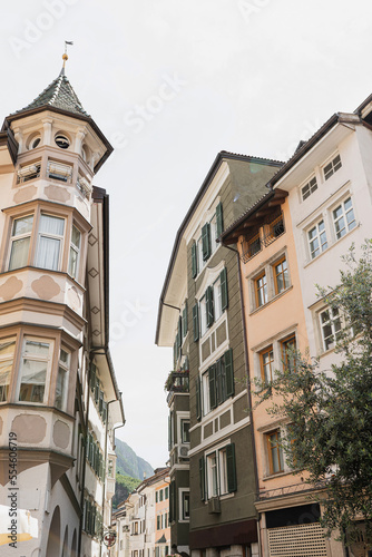 Historic architecture in Italy. Traditional European old town street buildings. Wooden windows  shutters and colourful pastel walls. Aesthetic summer vacation travel background