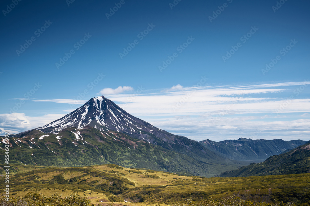 Fototapeta premium Summer landscape. Vilyuchinsky volcano against blue sky. Kamchatka peninsula