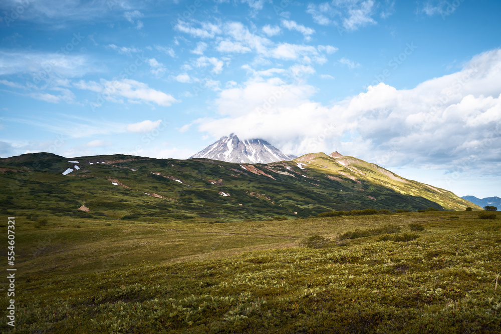 Summer landscape. Vilyuchinsky volcano against blue sky. Kamchatka peninsula