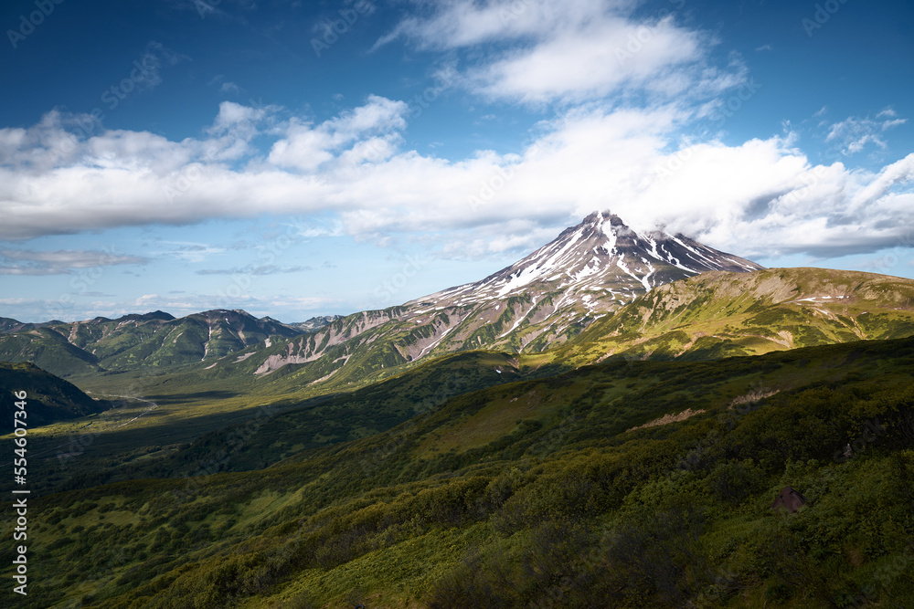 Fototapeta premium Summer landscape. Vilyuchinsky volcano against blue sky. Kamchatka peninsula