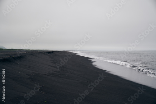 Deserted beach with black sand. East coast of Kamchatka peninsula