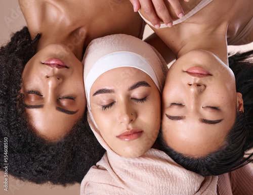 Diversity, woman and face, closed eyes for beauty, skincare wellness or cosmetics dermatology in studio. Natural makeup, facial care glow and interracial models relax, calm and peace for inclusion photo