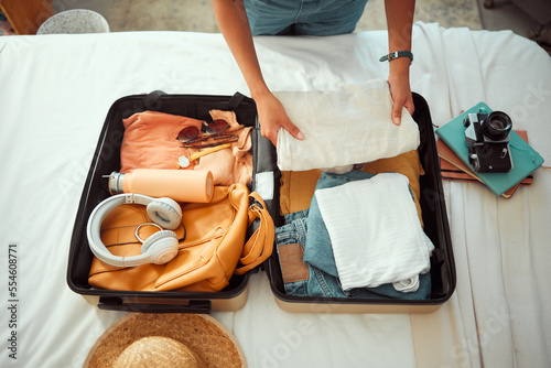 Photo Travel packing, above and hands of a woman with clothes, holiday luggage and prepare for international summer