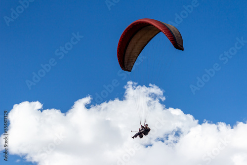 Rohtang Pass Paragliding in the blue sky with snow mountains of Manali in Himachal Pradesh. Natural beauty of Solang Valley in India. Famous tourist place in Manali in Himachal Pradesh in India.