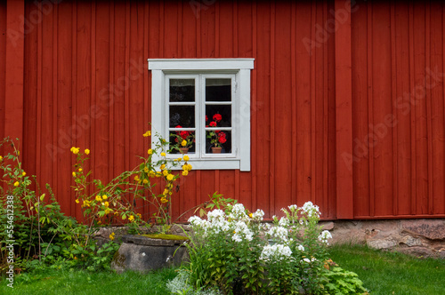 Bilde på lerret A typically red wooden cottage and barn in a Swedish summer landscape