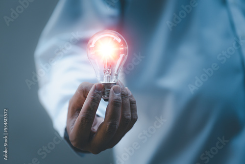 Innovation. Hand holding a light bulb for ideas. New concept with innovation and technology inspiration. Innovation in science and communication concepts, idea ideas. Creativity. Thinking.