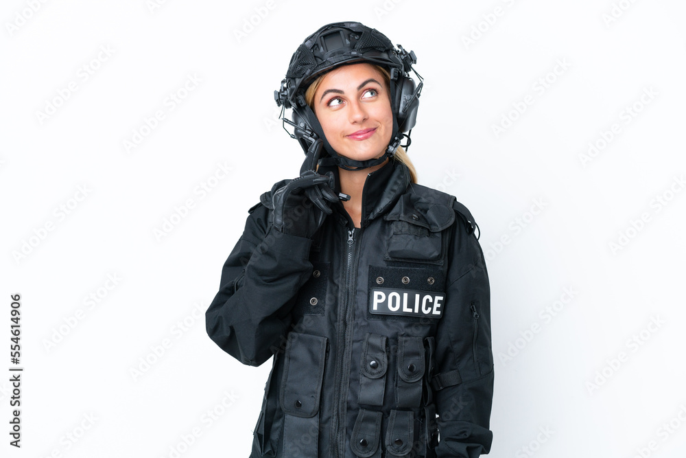 SWAT caucasian woman isolated on white background thinking an idea while looking up SWAT caucasian woman isolated on white background thinking an idea while looking up