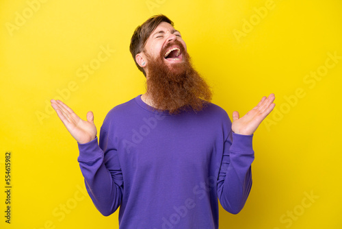 Redhead man with beard isolated on yellow background smiling a lot
