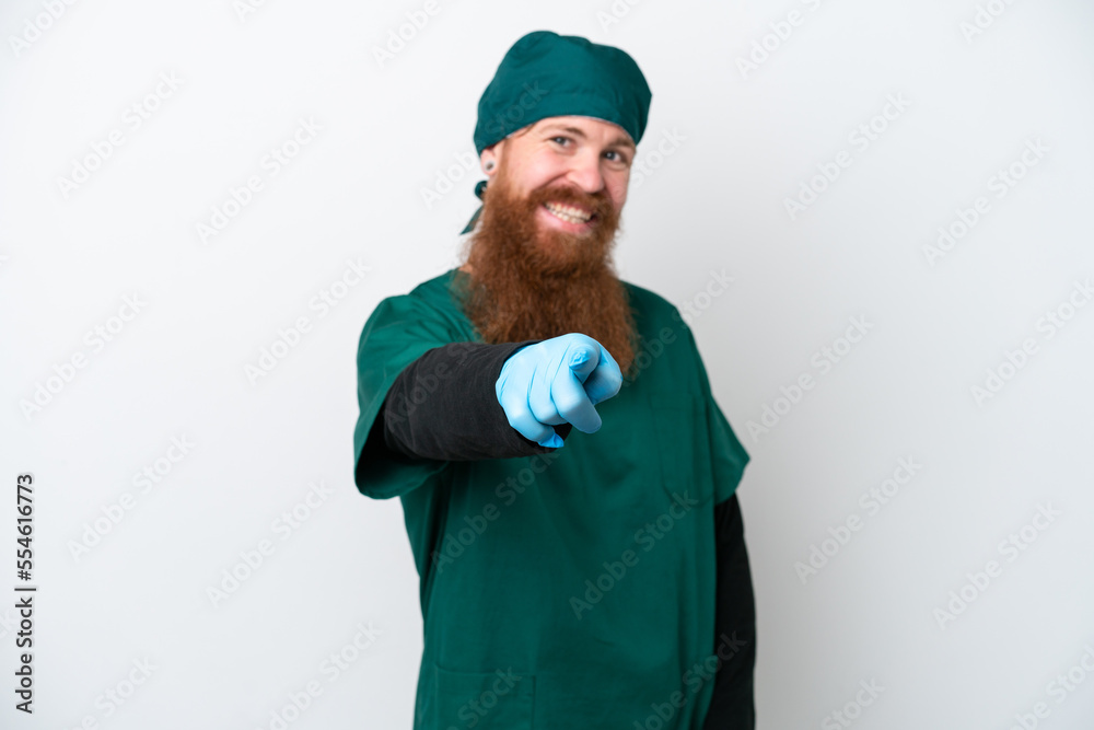 Surgeon redhead man in green uniform isolated on white background points finger at you with a confident expression Surgeon redhead man in green uniform isolated on white background points finger at you with a confident expression