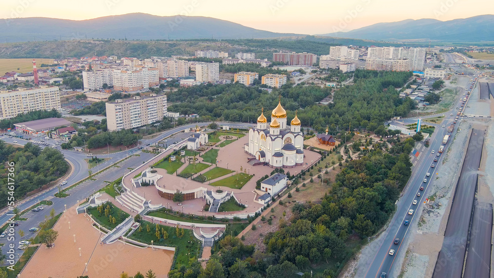 Gelendzhik, Russia. Cathedral of St. Andrew. The text along the M4-Don Highway is translated: Glory to Russia, Kuban-Pearl of Russia. Gelenzhik-City Resort. Sunset, Aerial View