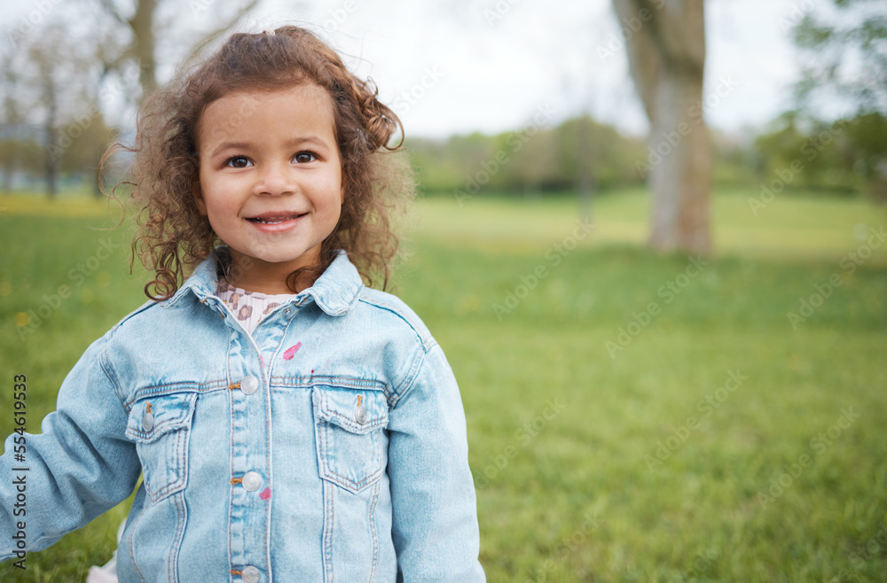 Child, face and park with grass field while outdoor for fun, travel and freedom in spring on vacation with smile, happiness and positive energy. Face of cute girl in nature with green background Child, face and park with grass field while outdoor for fun, travel and freedom in spring on vacation with smile, happiness and positive energy. Face of cute girl in nature with green background